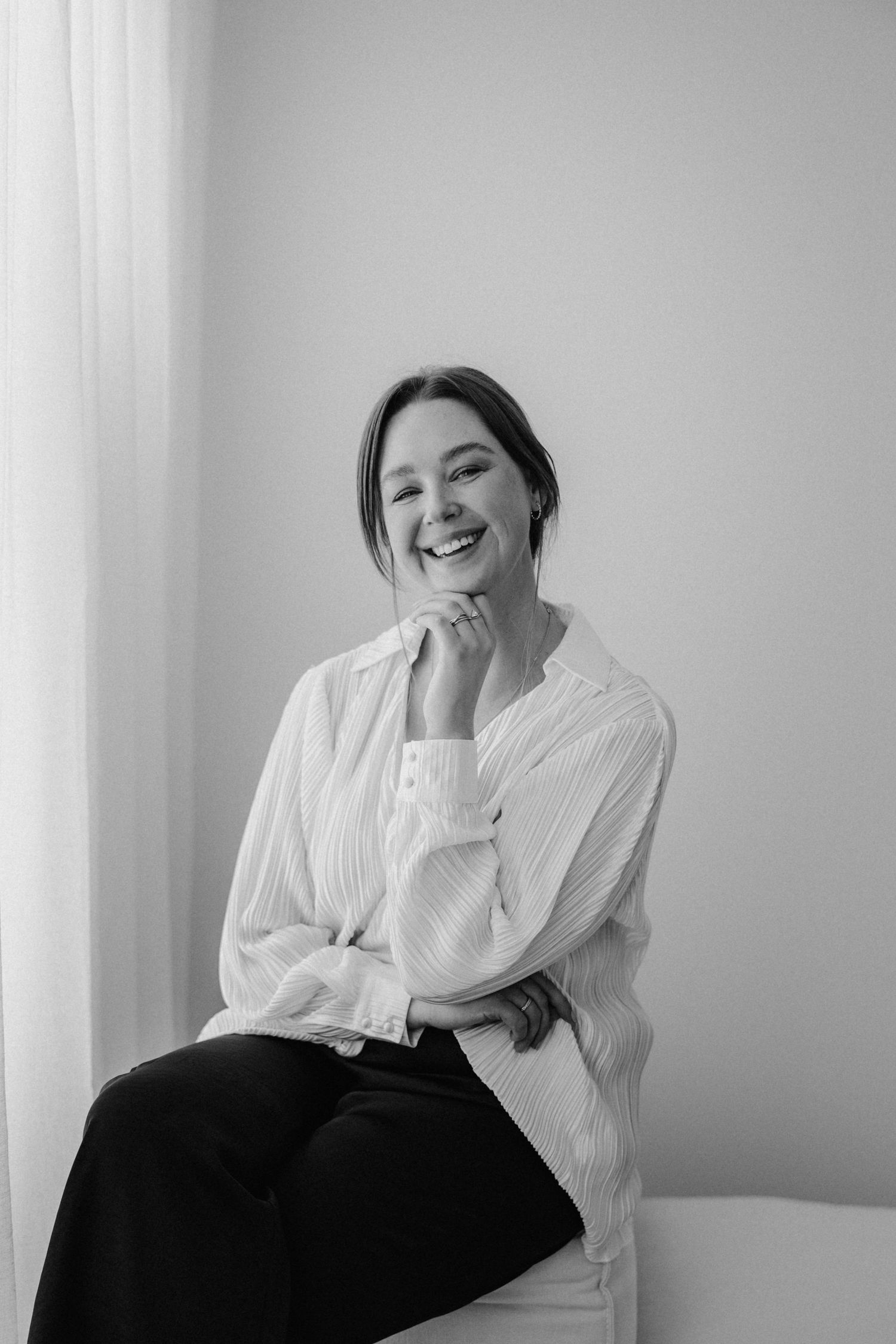 Smiling portrait of a photographer in her home studio in Tea Tree Gully, Adelaide, South Australia.