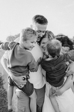 Lauren Lunn captures Adelaide family laughing and cuddling together on the beach at sunset for their family photography session.