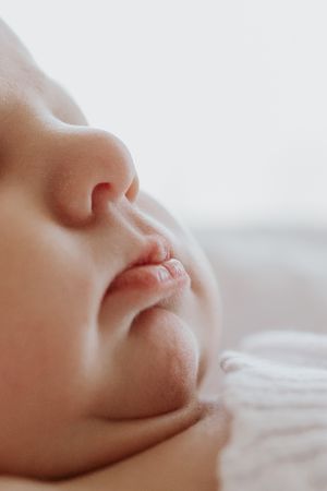 A close up shot of a newborn baby showcases their tiny features during Adelaide newborn photo session in Lauren Lunn's home Studio.