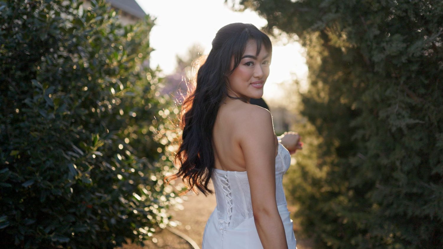 Wedding party forming a tunnel of raised arms for celebration.