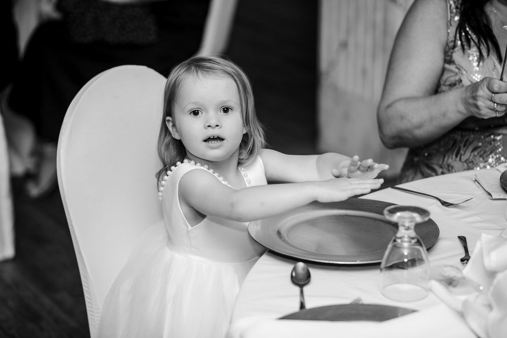 Black and white photo series showing reception guests enjoying dinner and drinks at formal dining tables.