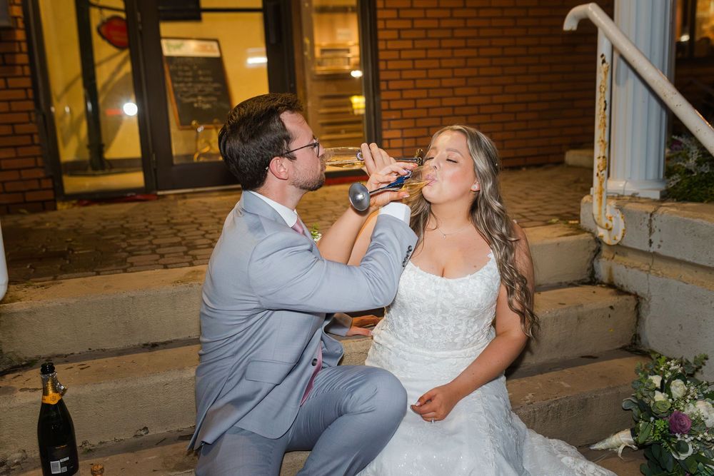 Couple sharing a romantic dance on a brick patio at a wedding reception.