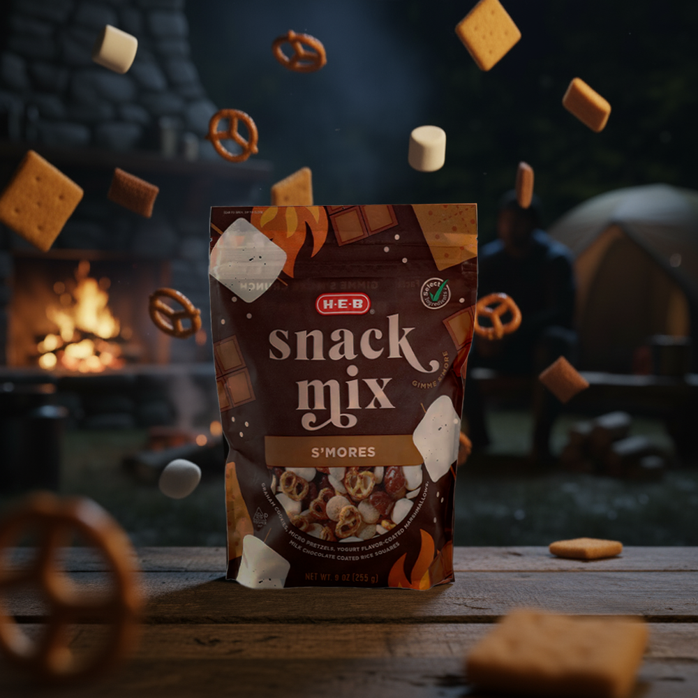 A dark moody product shot of HEB chocolate snack mix with pretzels and marshmallows floating around the package.
