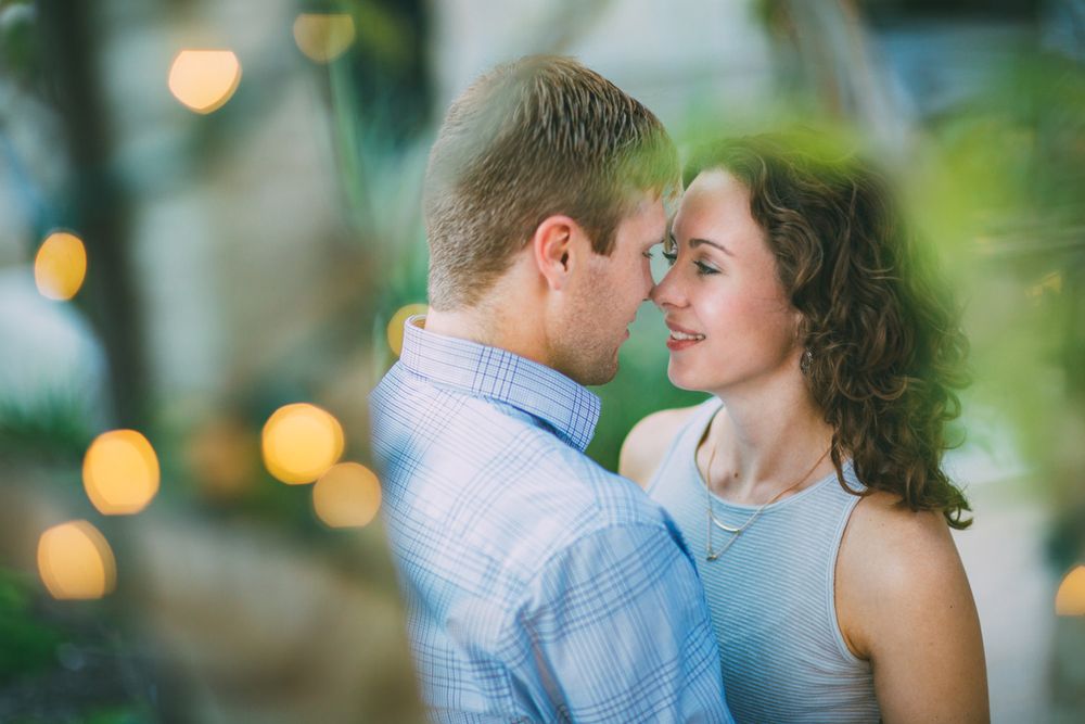 Romantic couple portraits in soft focus with bokeh lights in the background.