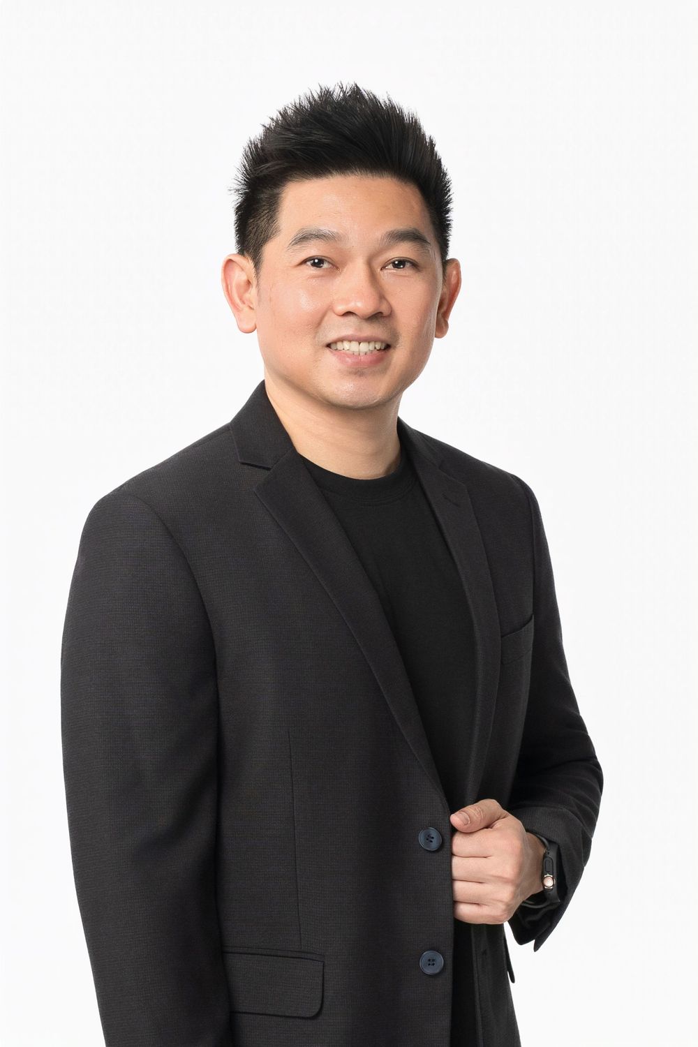 A portrait of someone in a black suit jacket standing against a white backdrop, showing both formal and casual poses.