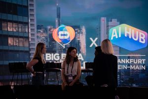 Conference room scene with AI Hub branding and city skyline backdrop.