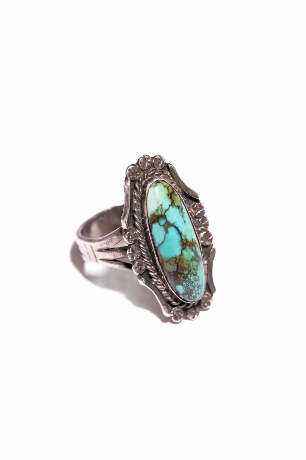 Southwestern style turquoise ring with detailed silver metalwork and vintage patina.