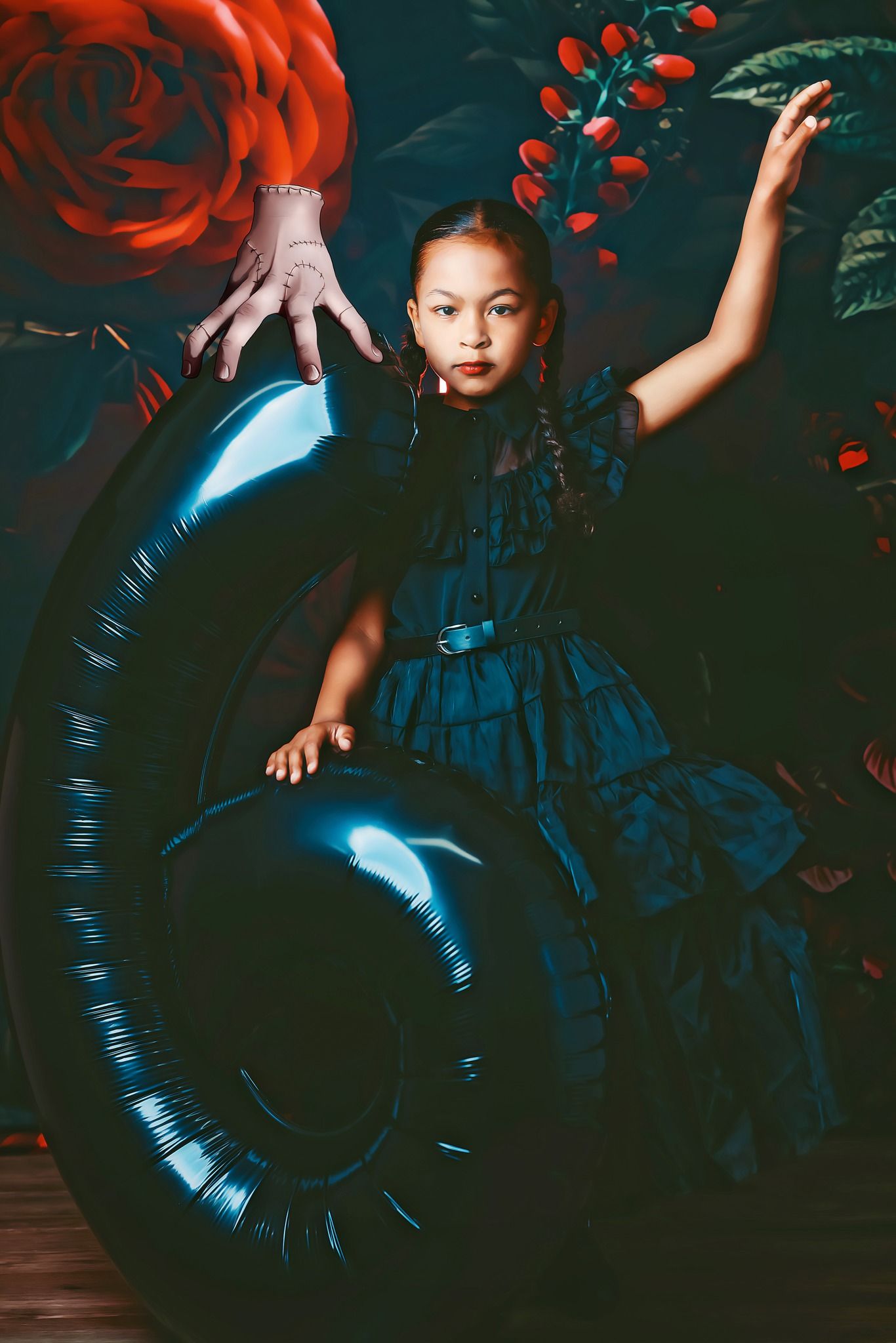 Artistic portrait with blue circular prop and red roses in dark moody setting.