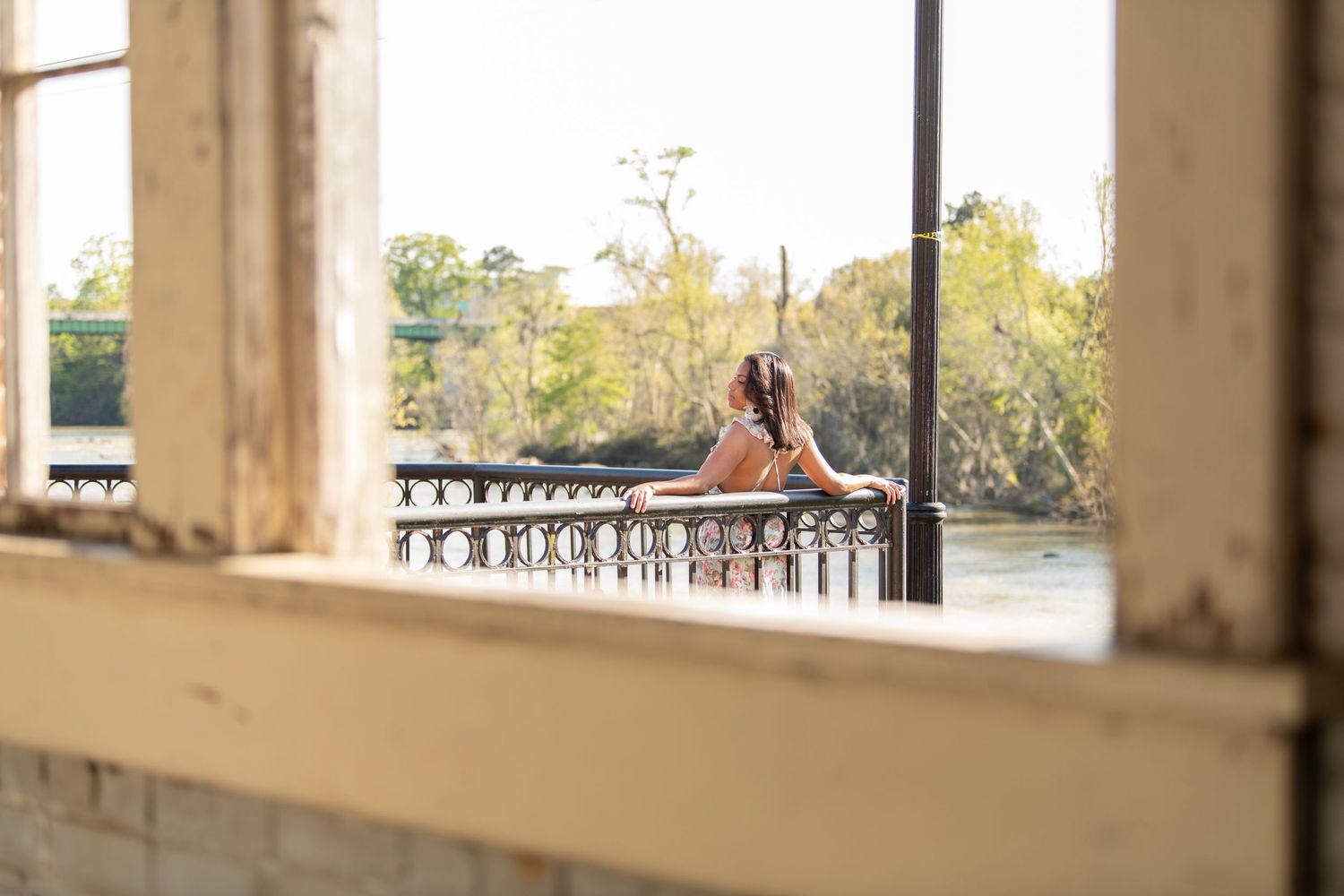 Woman poses on overlook by the river in Columbia, SC