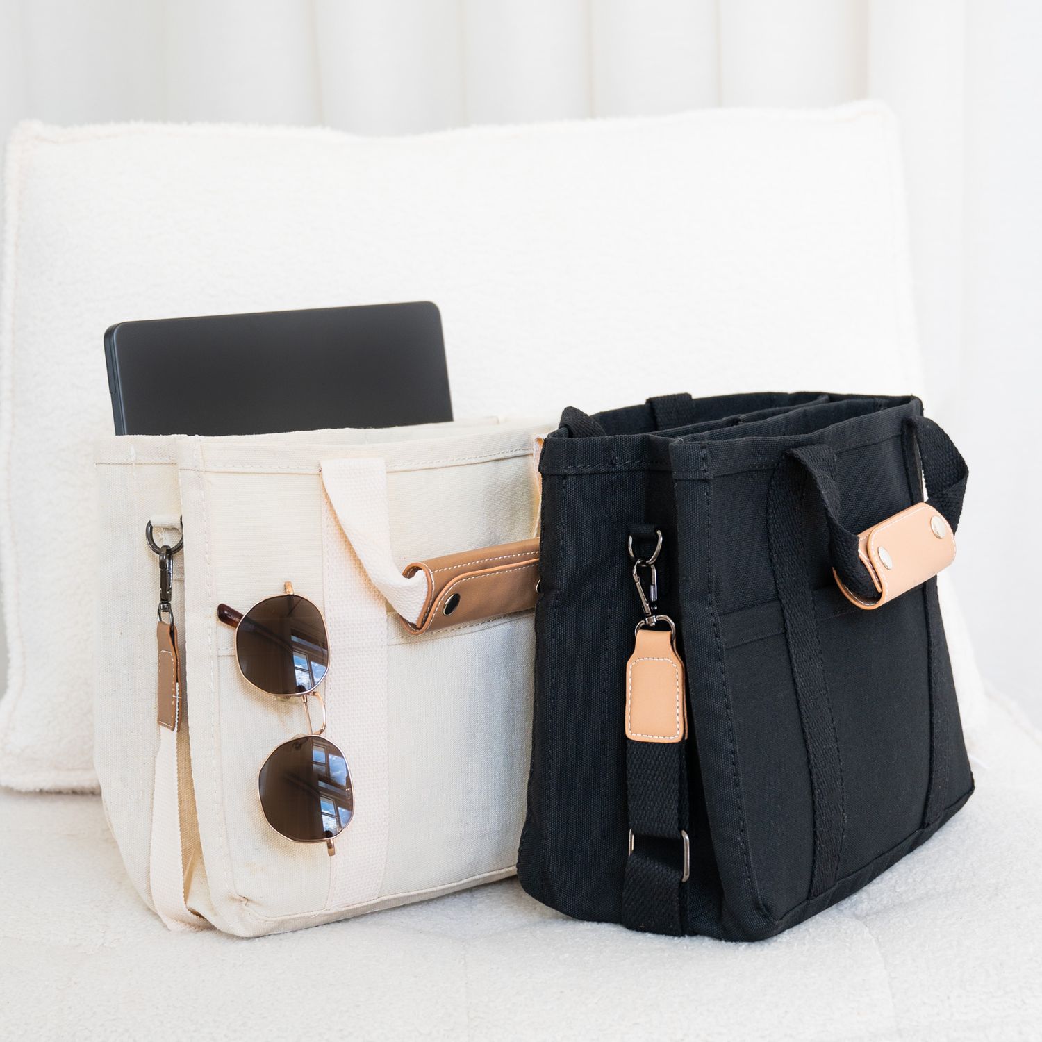 Luxe Little One New Range. White and black canvas tote bags with sunglasses and leather straps displayed on a light background.