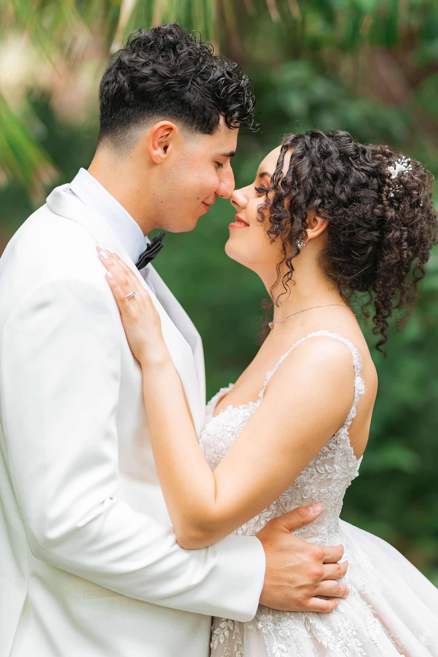 Intimate wedding portrait featuring luxury details and formal attire.