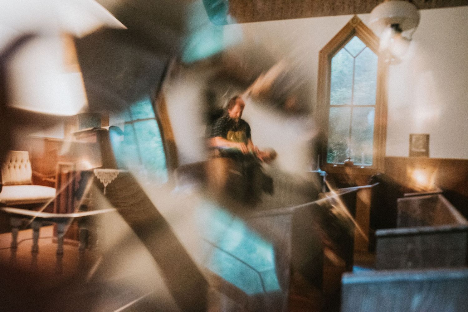 Abstract motion blur photograph of a rustic kitchen interior with window light.