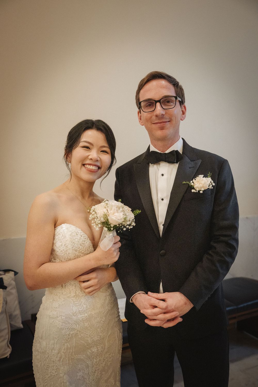 Bride and groom share joyful moments during formal wedding portraits.