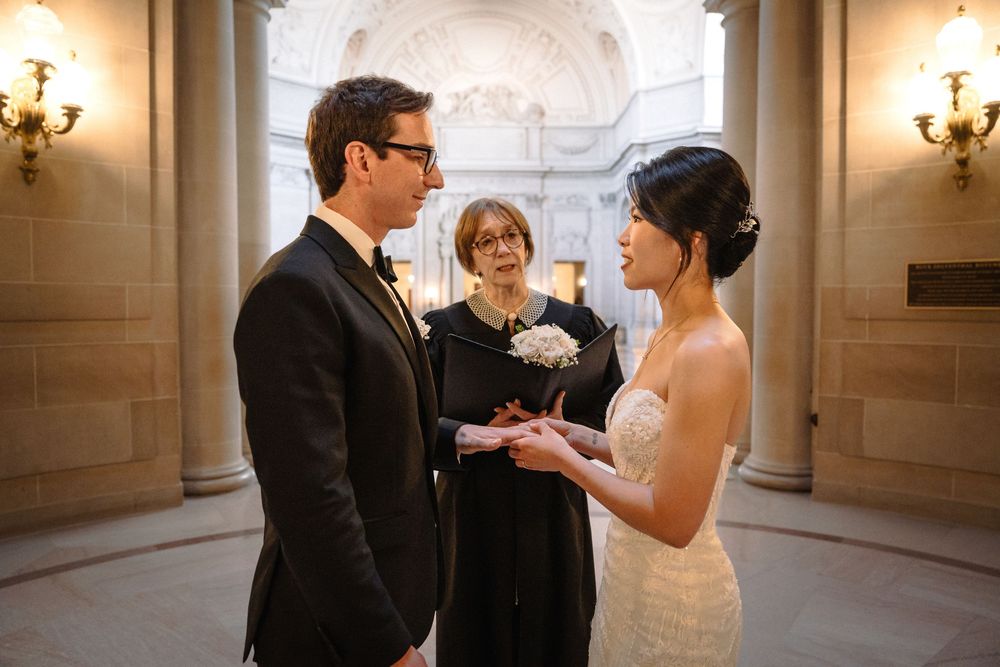 Candid wedding ceremony sequence captured in a historic rotunda with beautiful natural lighting.