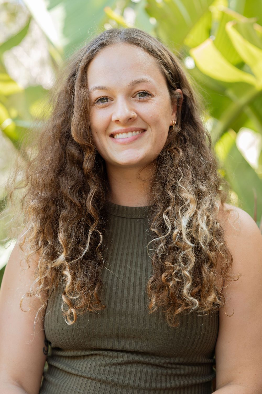 Portrait against tropical foliage background in natural lighting.