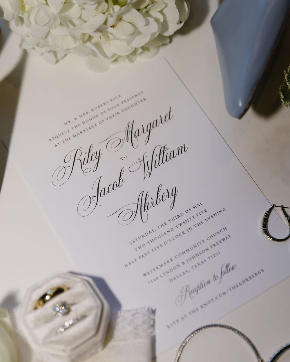 Elegant wedding invitation with calligraphy font displaying the couples names and wedding details.