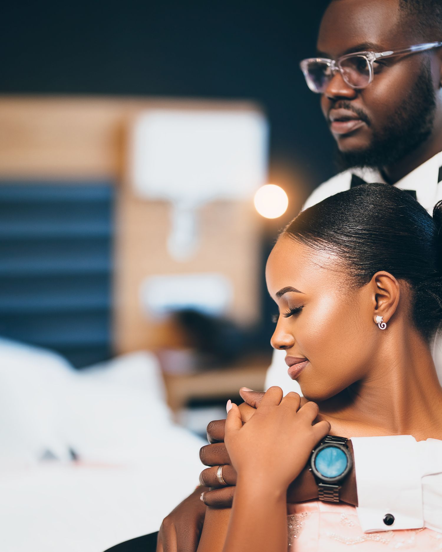 Intimate black and white portrait of couple in tender romantic moment with elegant jewelry and styling.