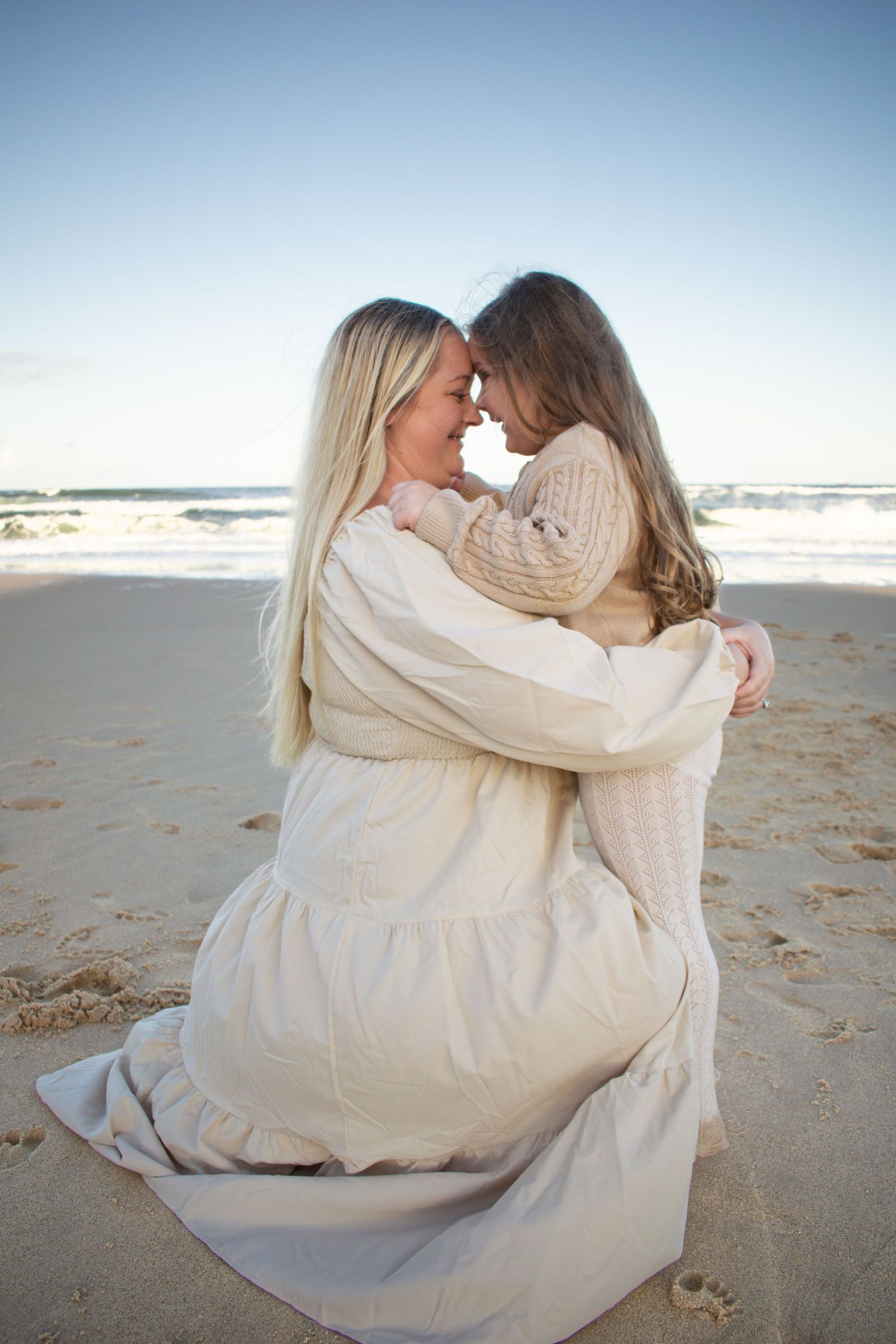 Newcastle motherhood photographer of a mother holding her daughter at the beach