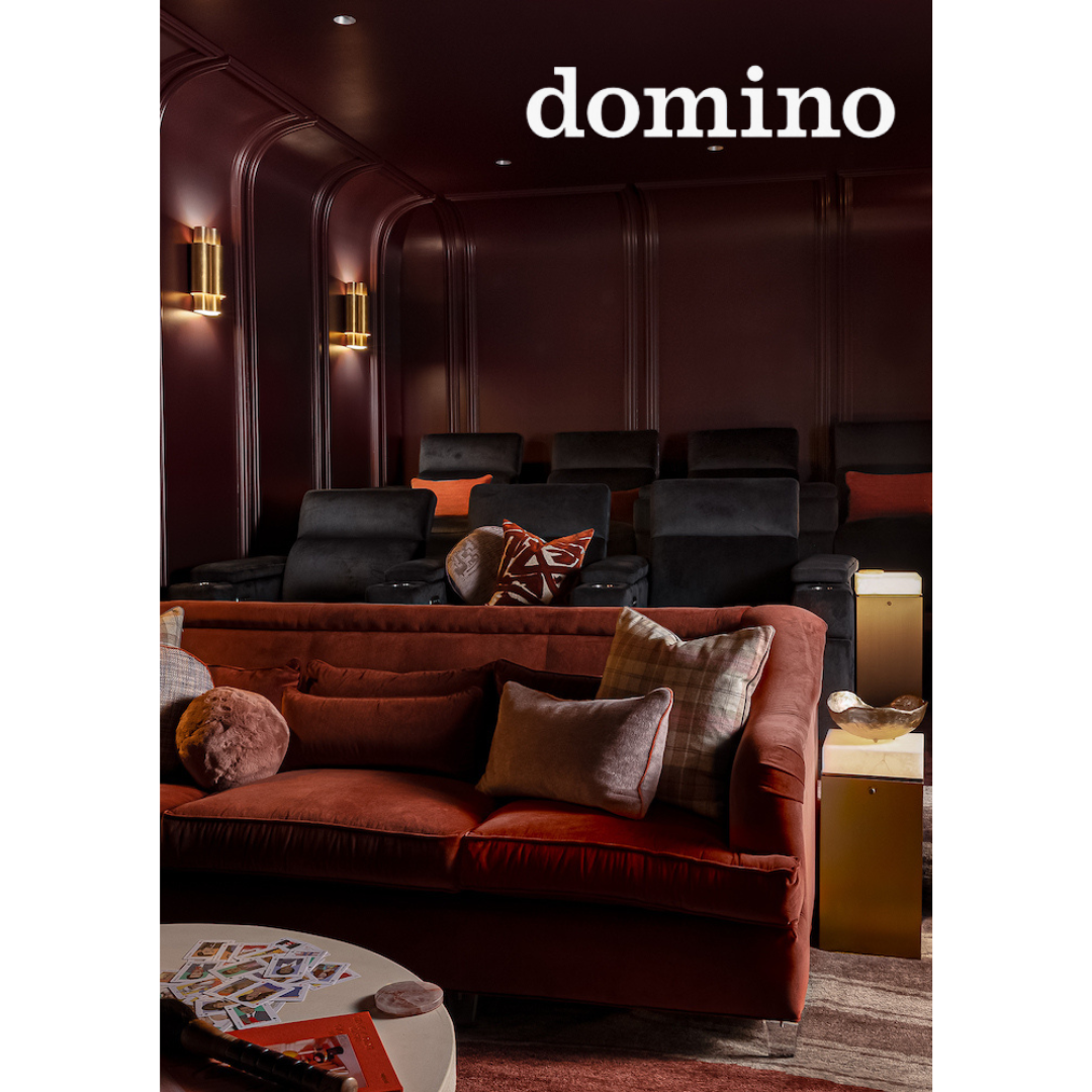 Heather Ison for Domino. Luxurious theater room with plush velvet sofa and dramatic burgundy curved walls designed by Indigo Pruitt.