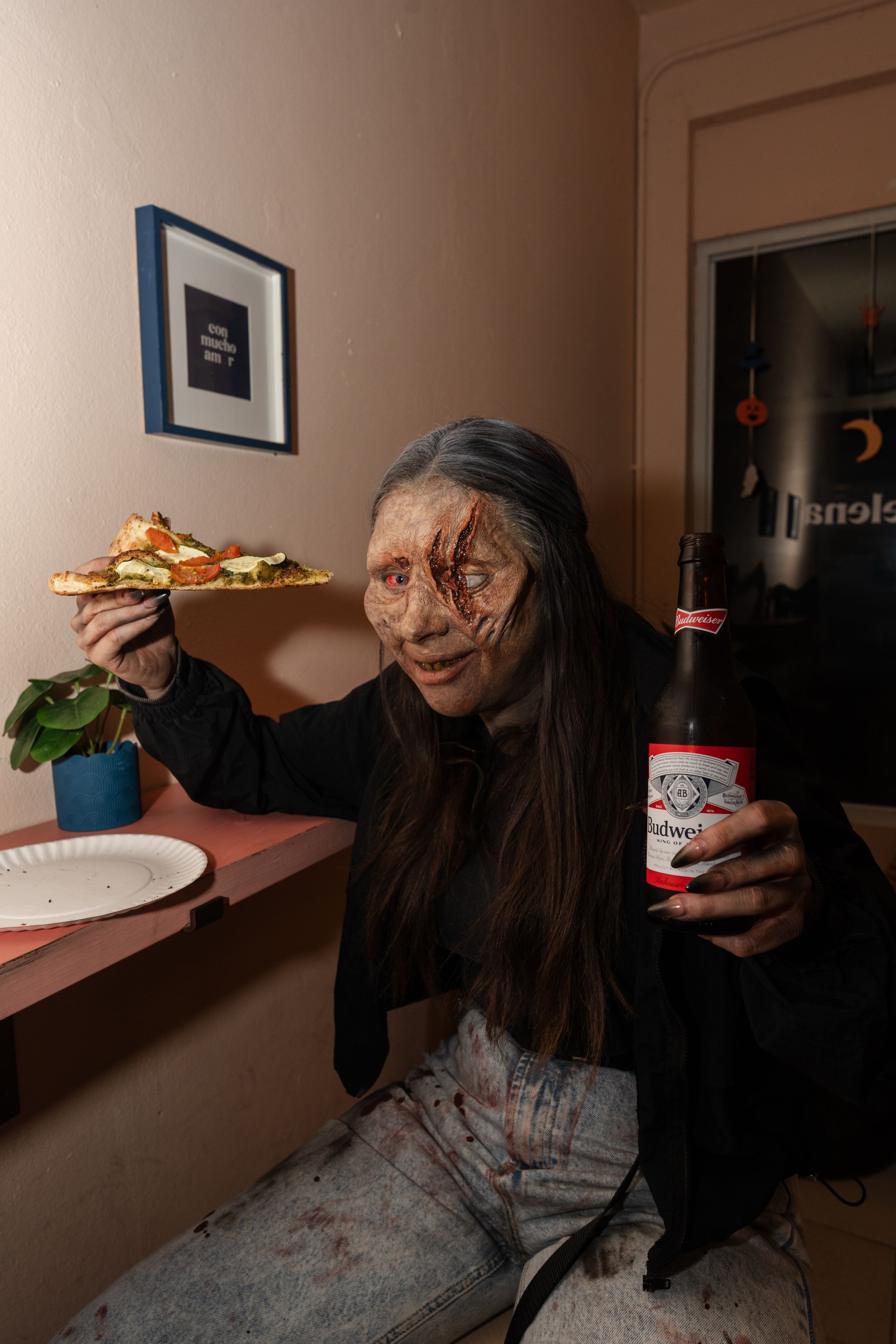 Zombie eating a pizza.