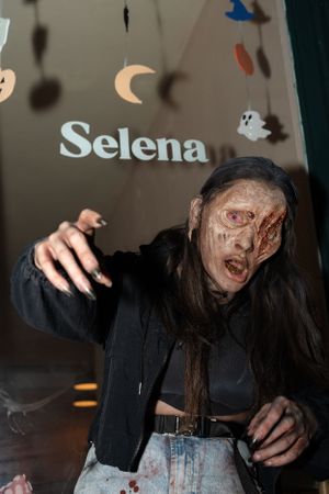 Zombie eating a pizza.