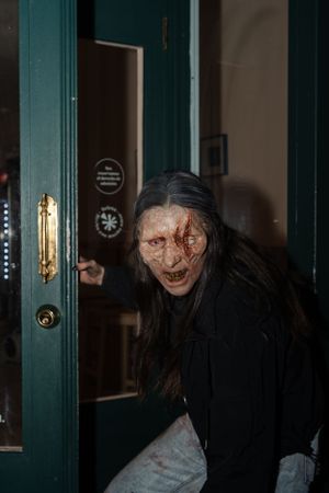 Zombie eating a pizza.