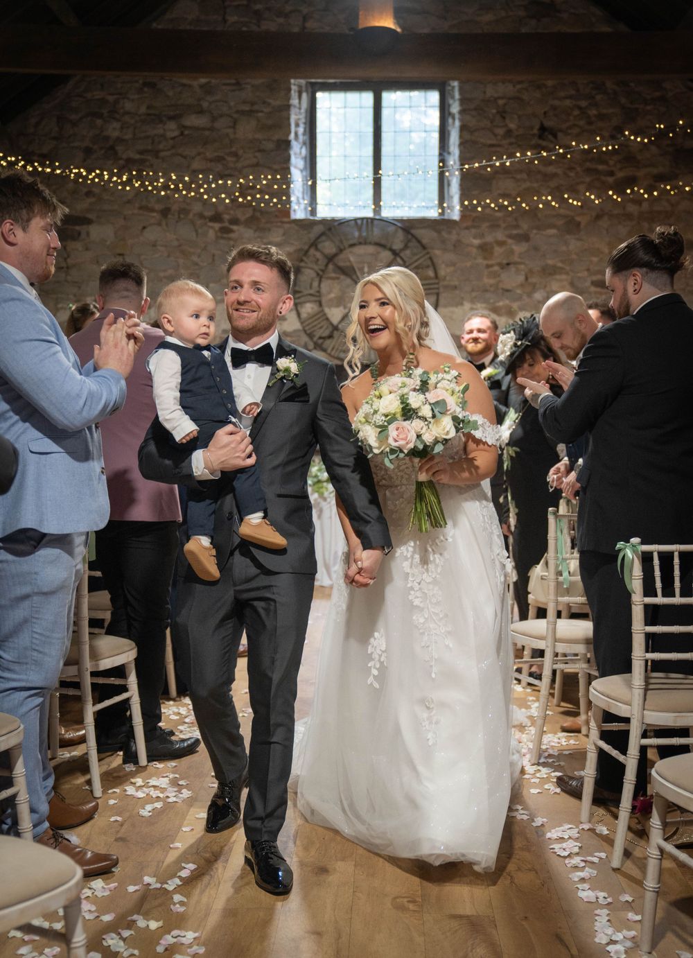 Wedding ceremony featuring dancing and celebrations in a rustic venue with string lights.