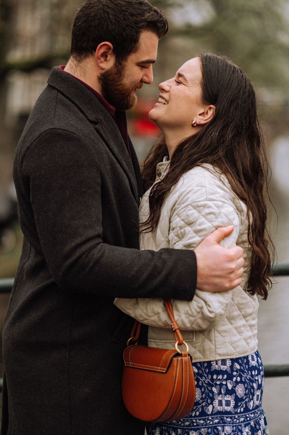 Romantic couple in winter clothes sharing tender moment outdoors.