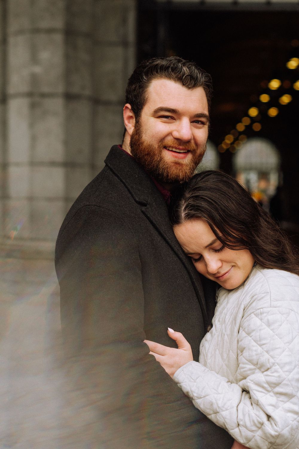 Intimate moment captured under warm lighting in an indoor setting.