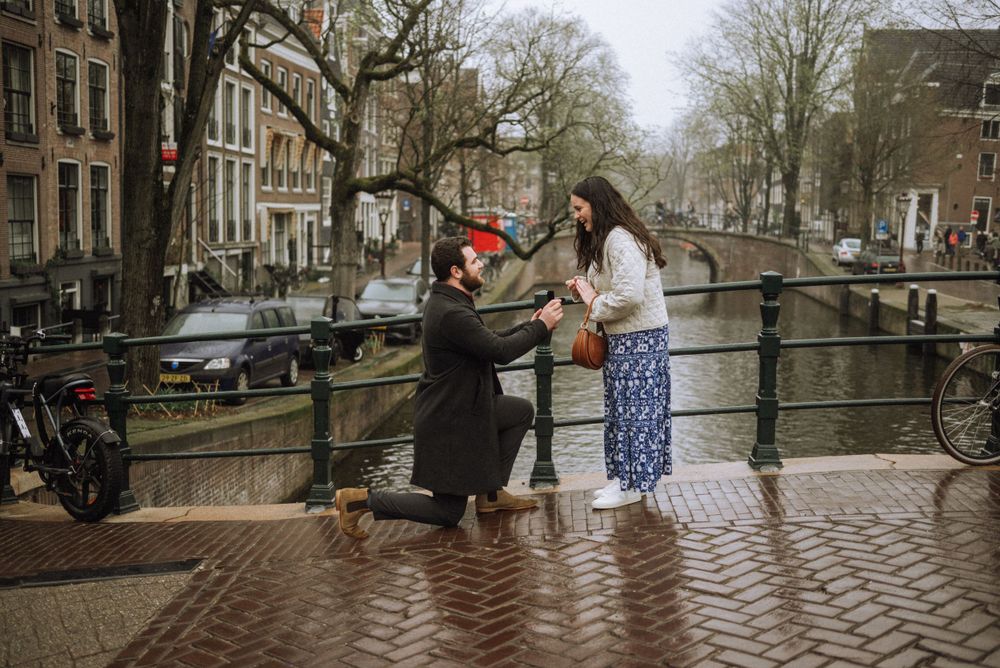 People gathered along Amsterdam's iconic canal bridges and cobblestone streets.