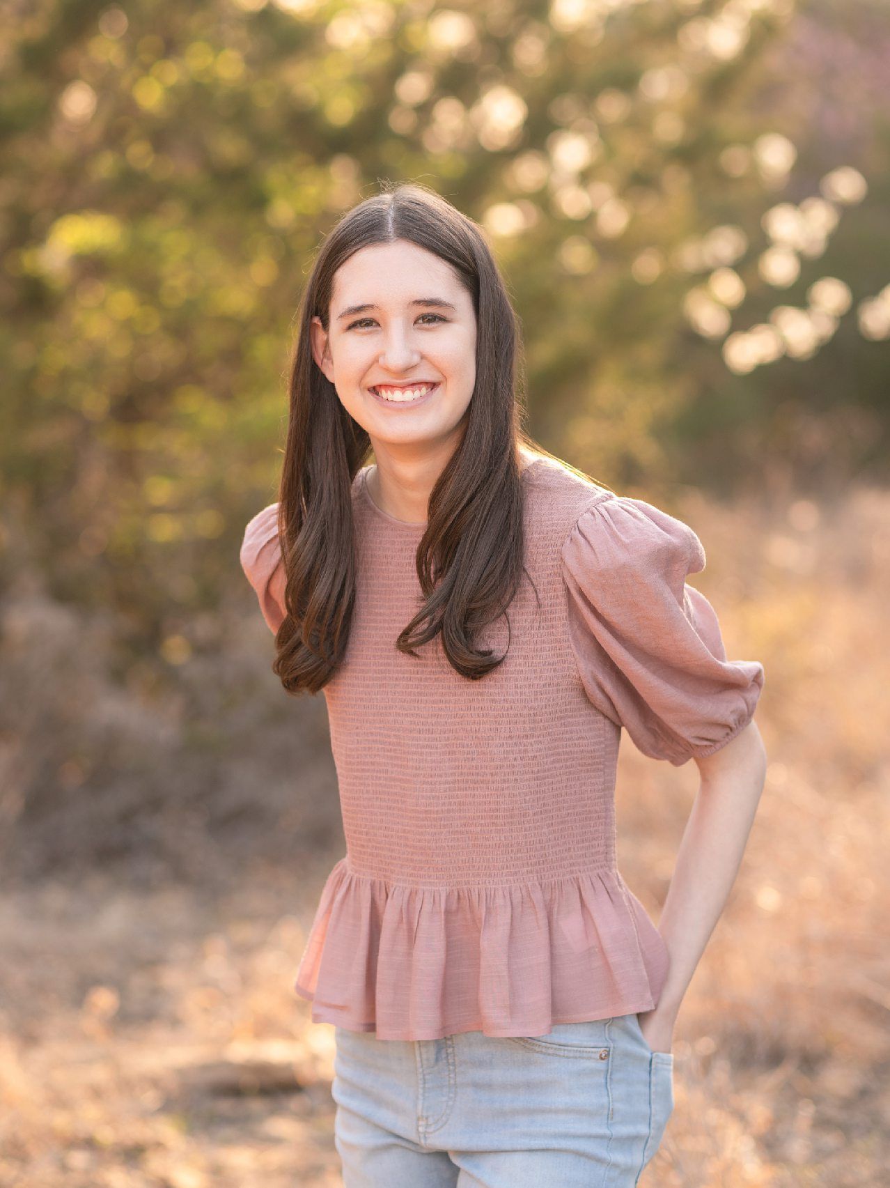 Senior Girl portraits for in Light Grassy Field with Spring Blossoms by Bartlesville Photographer Kristi Bray