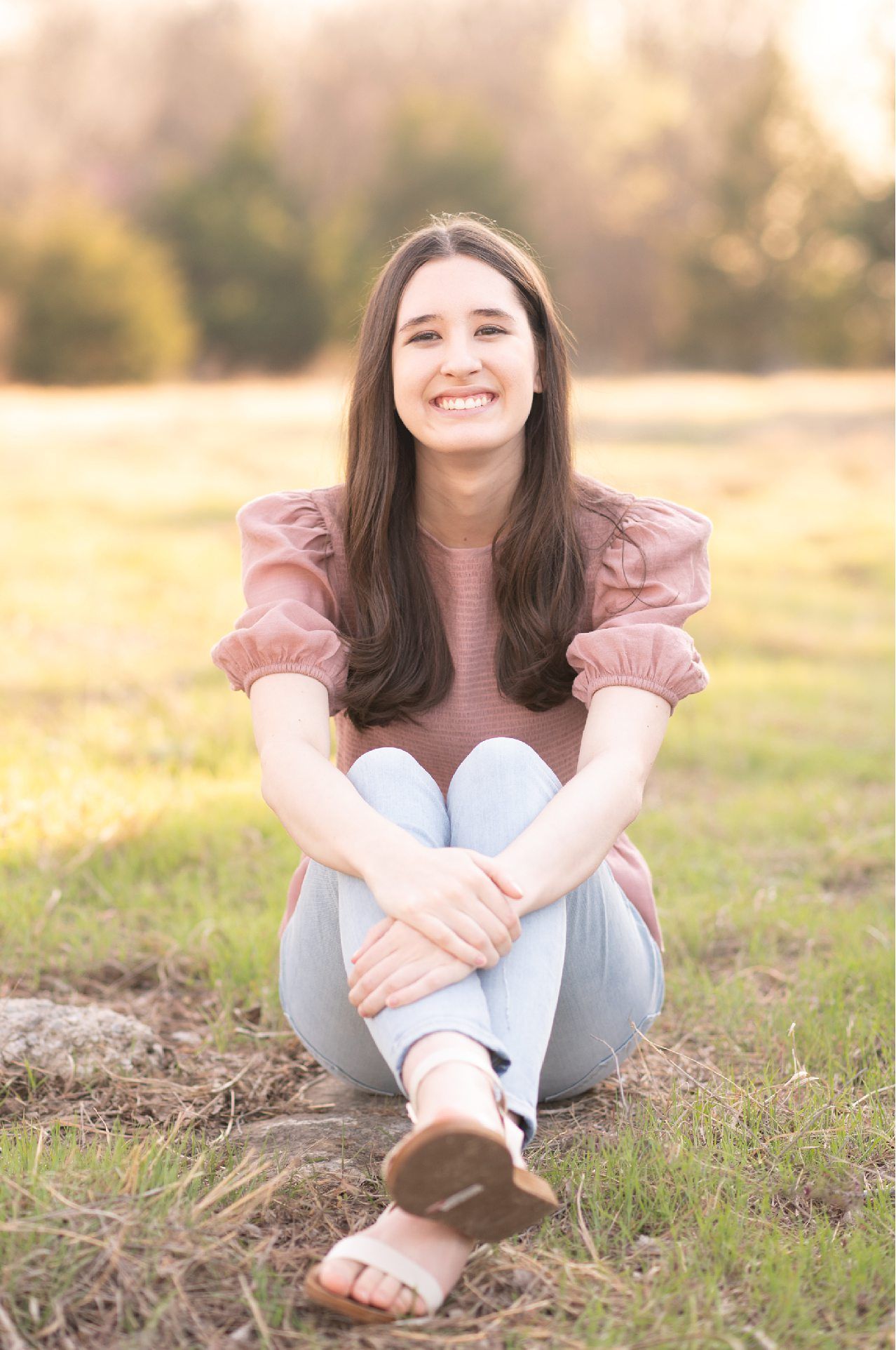 Senior Girl portraits for in Light Grassy Field with Spring Blossoms by Bartlesville Photographer Kristi Bray