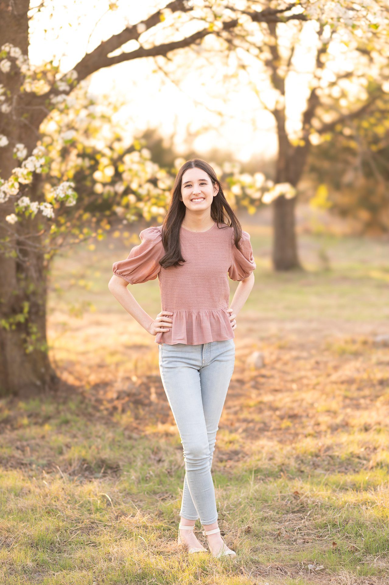 Senior Girl portraits for in Light Grassy Field with Spring Blossoms by Bartlesville Photographer Kristi Bray