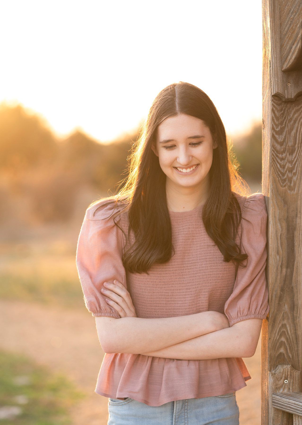 Senior Girl portraits for in Light Grassy Field with Spring Blossoms by Bartlesville Photographer Kristi Bray