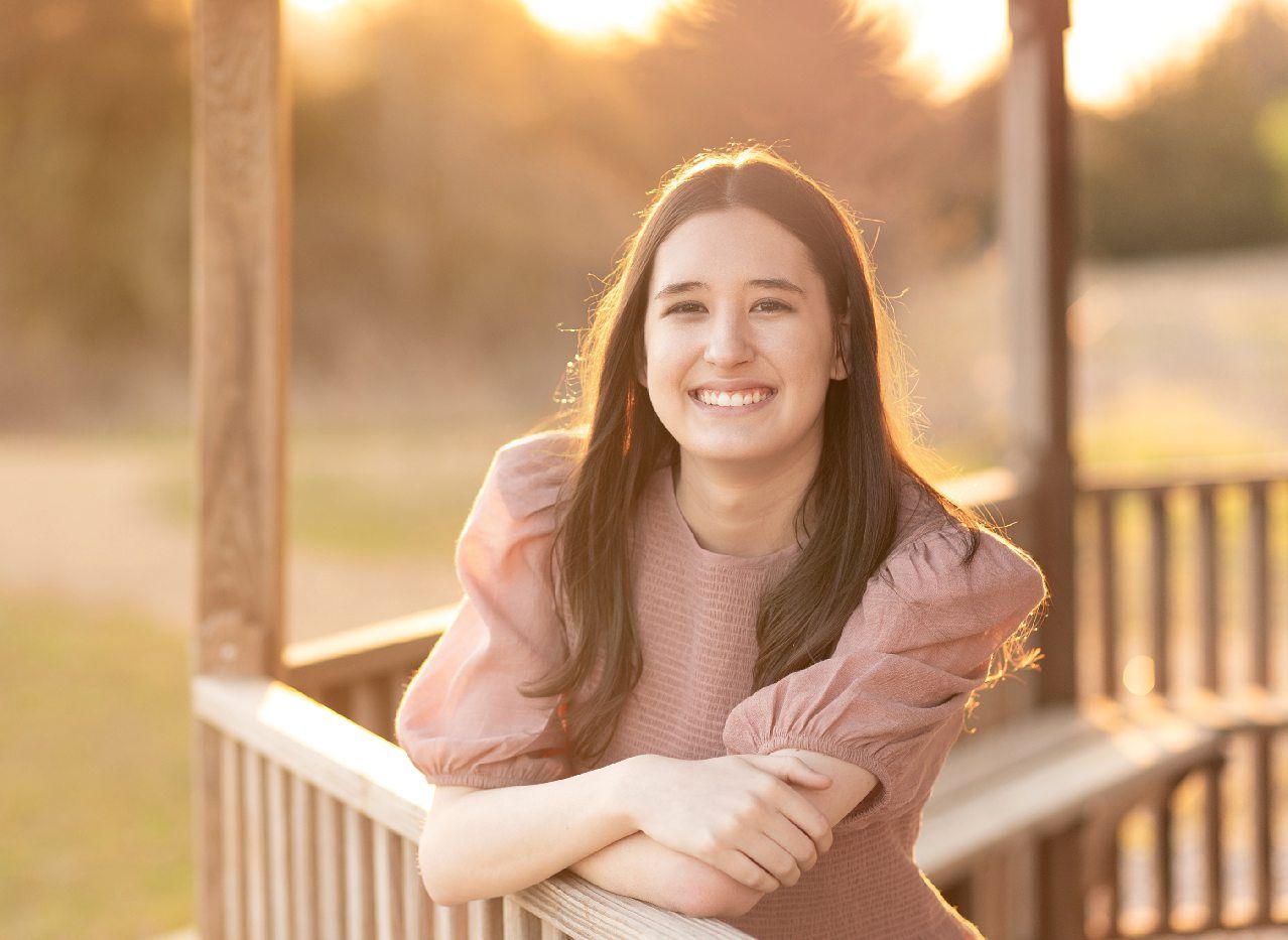Senior Girl portraits for in Light Grassy Field with Spring Blossoms by Bartlesville Photographer Kristi Bray