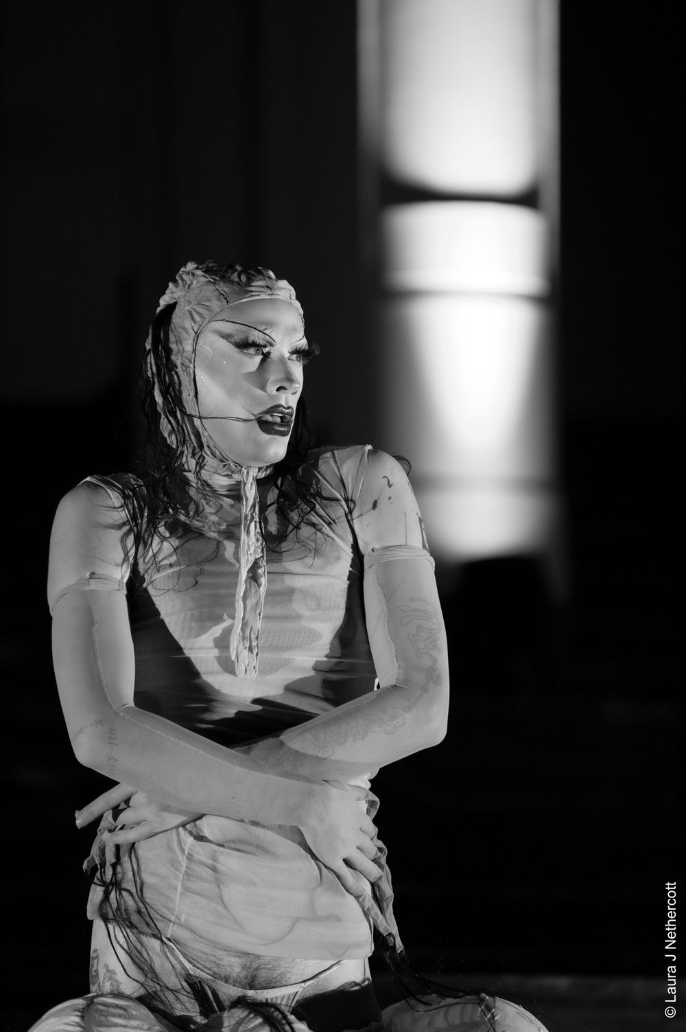 Black and white performance art showing intense emotional poses in dramatic lighting.
