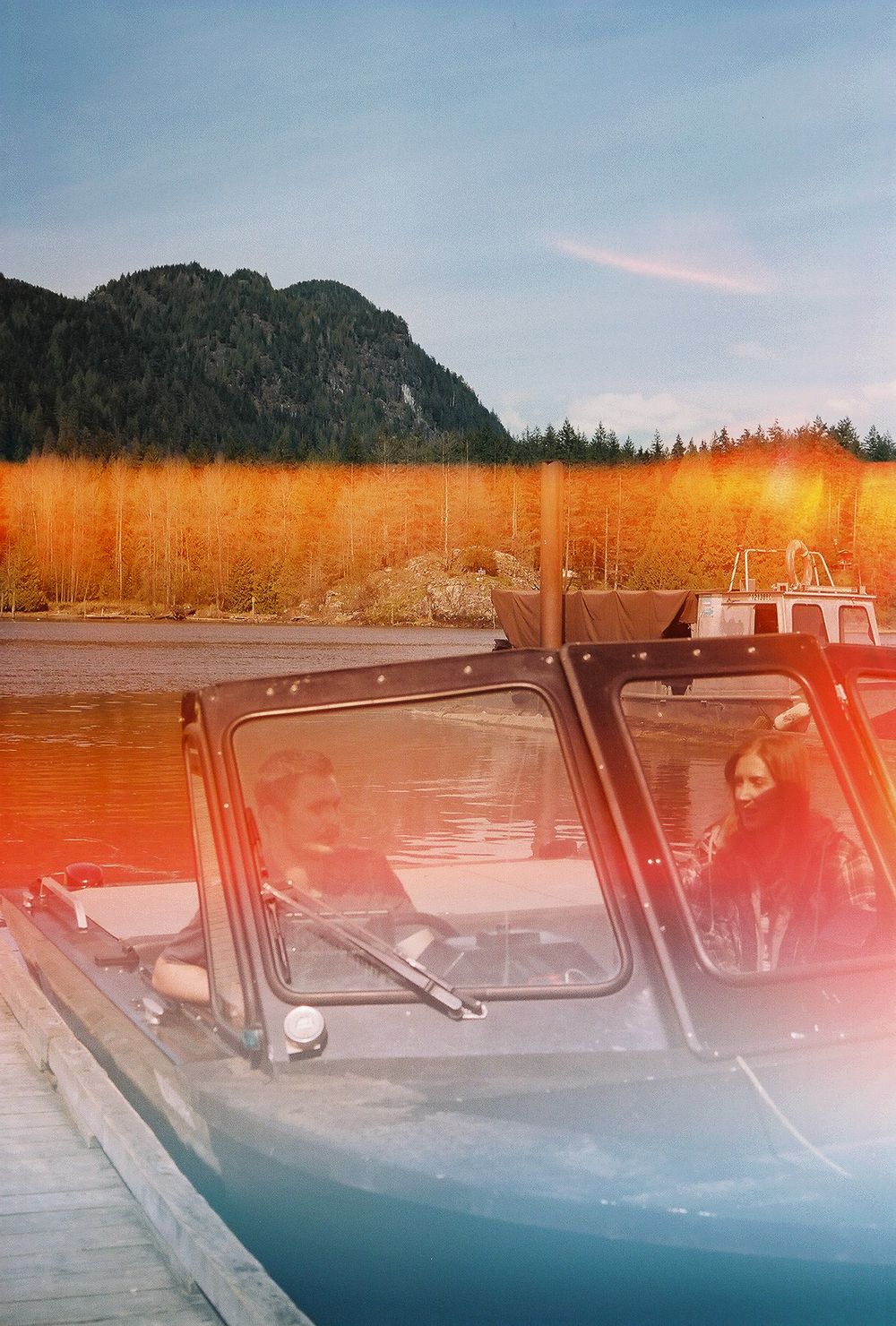 Series of mountain lake views with boats at dock during golden hour.