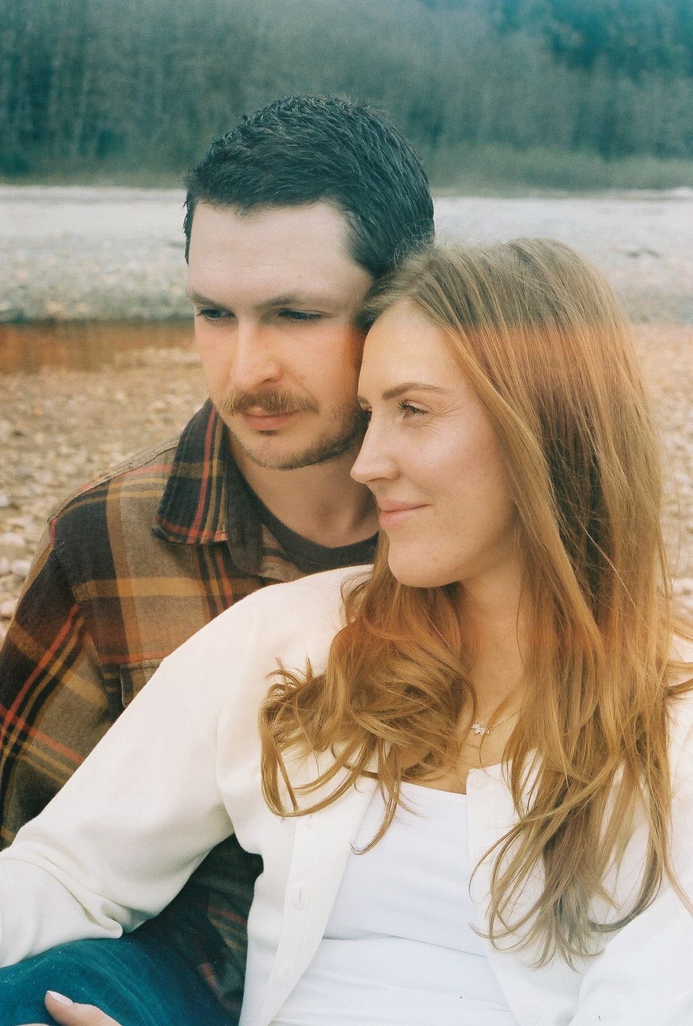 Candid moments of affection captured against a natural outdoor backdrop.