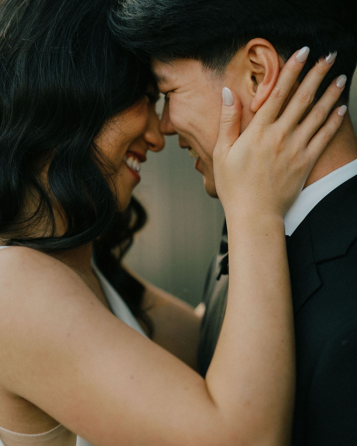 Romantic couple portraits at The Refinery, blending modern architecture and lush greenery, captured candidly.