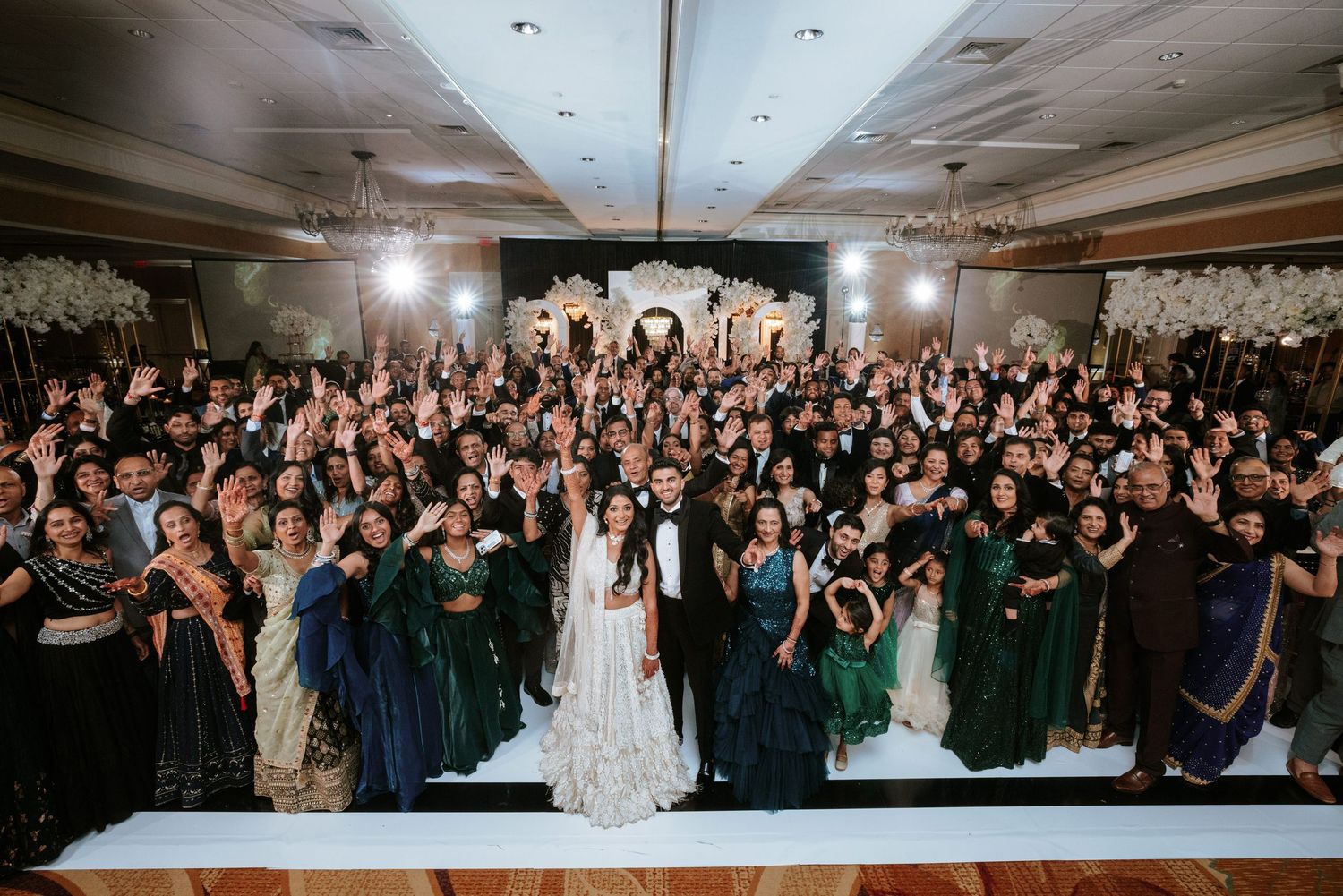 South Asian wedding reception at Bridgewater Marriott with bride, groom, and guests celebrating on a packed dance floor.
