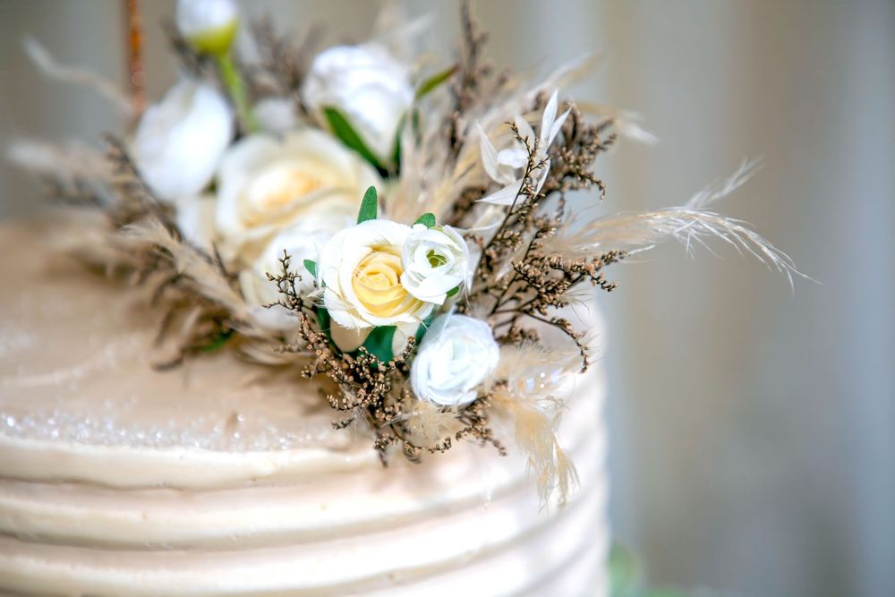 Close-up detail of a wedding cake decorated with delicate yellow roses and greenery.
Mecure Hotel Haydock