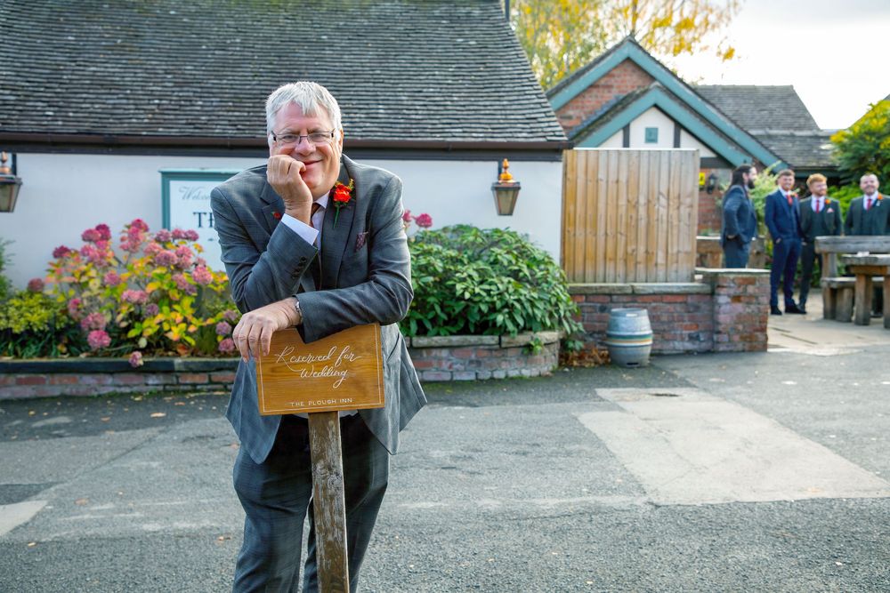 Rustic outdoor venue with stone buildings and colorful flower arrangements.
The Plough Inn