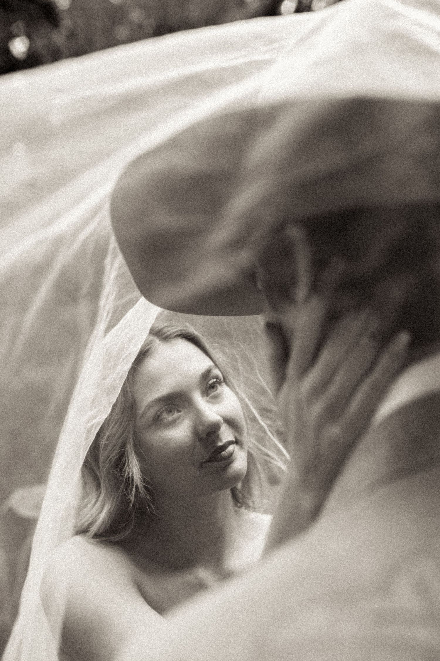 A black and white artistic photo sequence showing a figure in soft focus with flowing white fabric creating a dreamy effect.