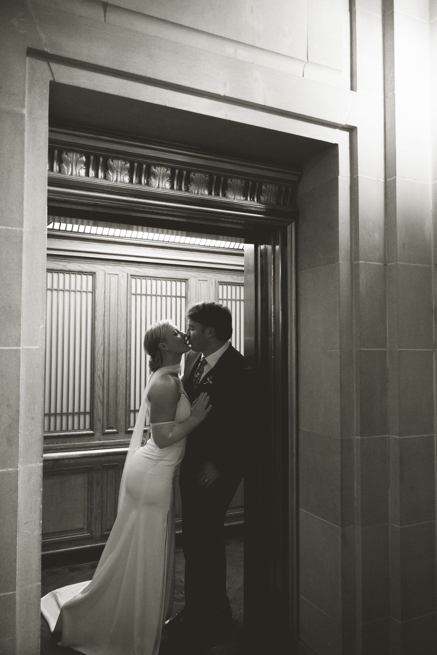 A black and white triptych photo sequence showing a couple in wedding attire entering an elevator.
