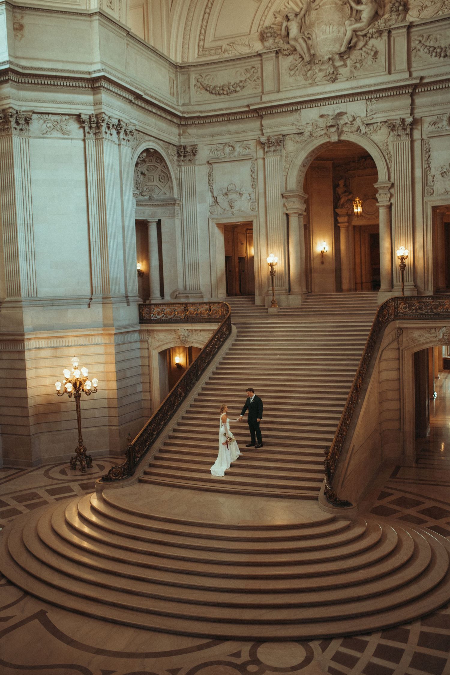 Wedding photography sequence showing a couple on ornate marble steps in a grand historic building.
