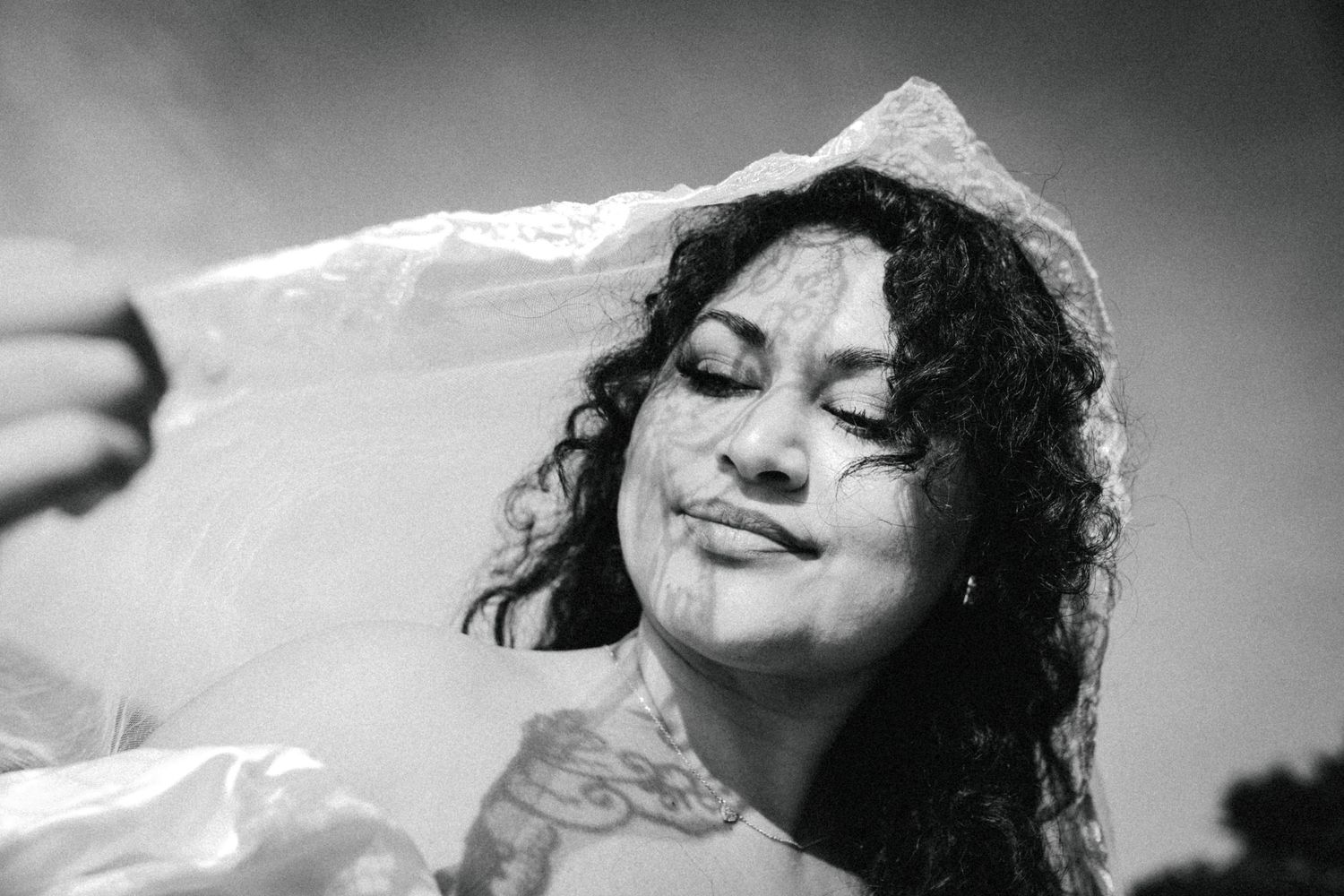 Black and white portrait photo series showing a woman with curly hair in various expressive poses and moods.