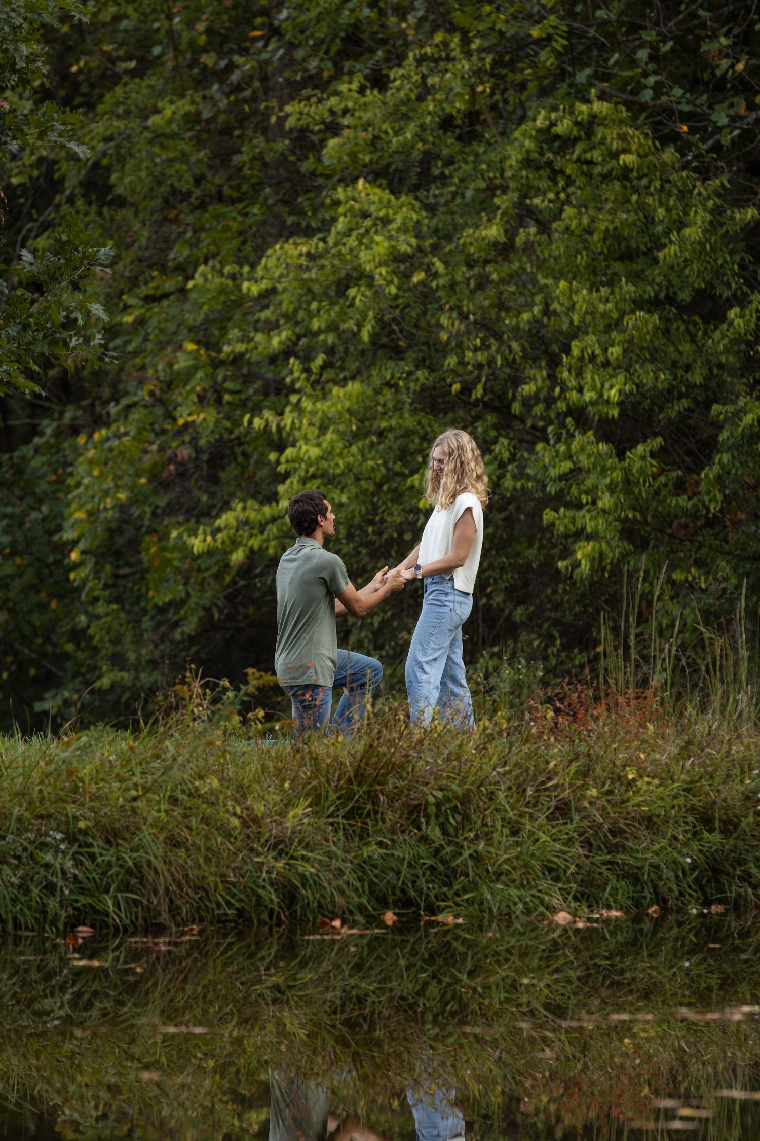 A special moment captured by a lake with trees in autumn colors.