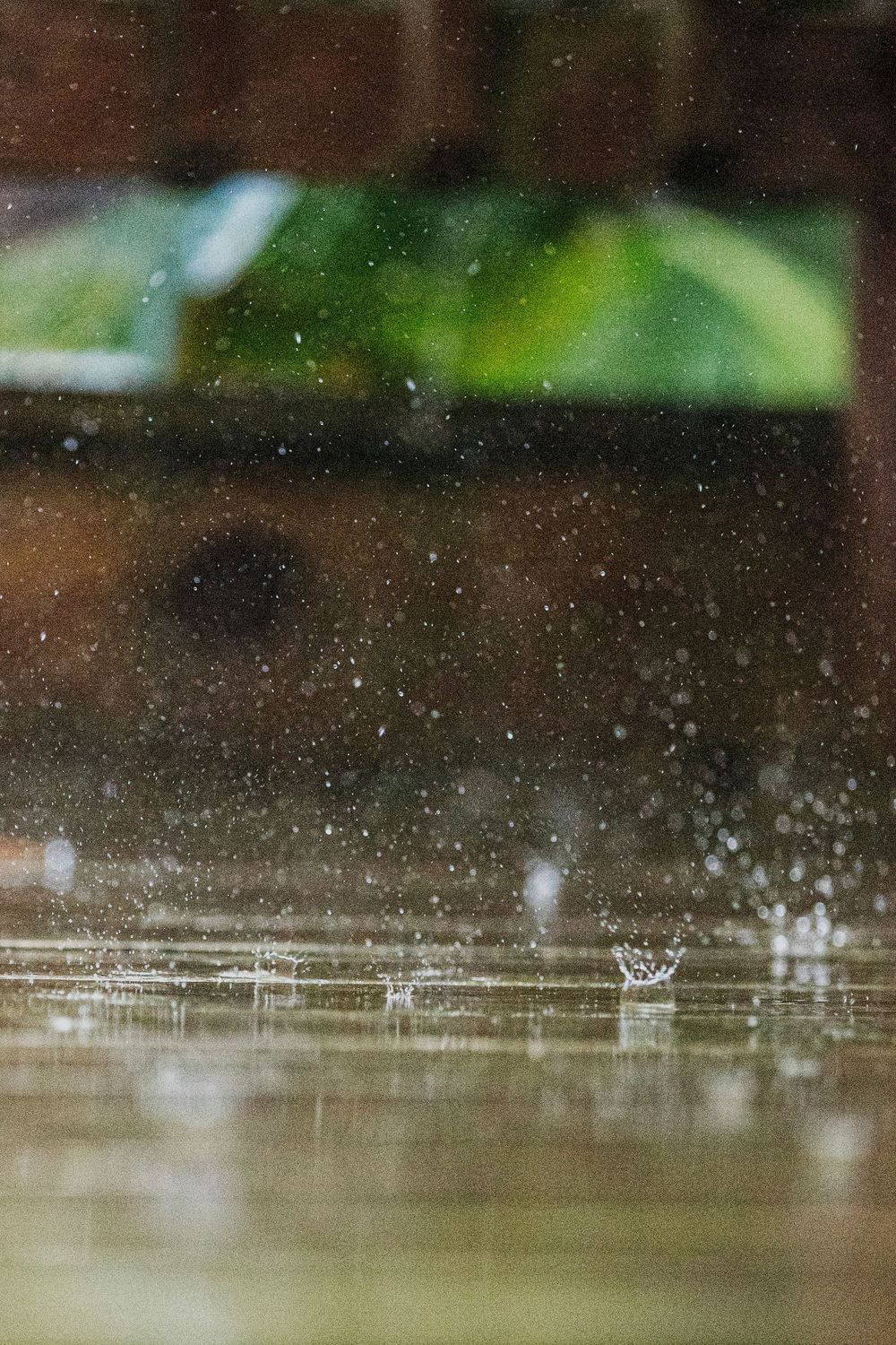 Water droplets splashing on a reflective surface create a dynamic pattern of ripples and sprays.