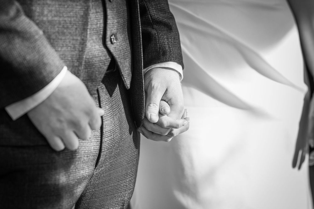 Close-up detail shots of formal wedding attire showing suit jackets, white shirts, and dress clothing.