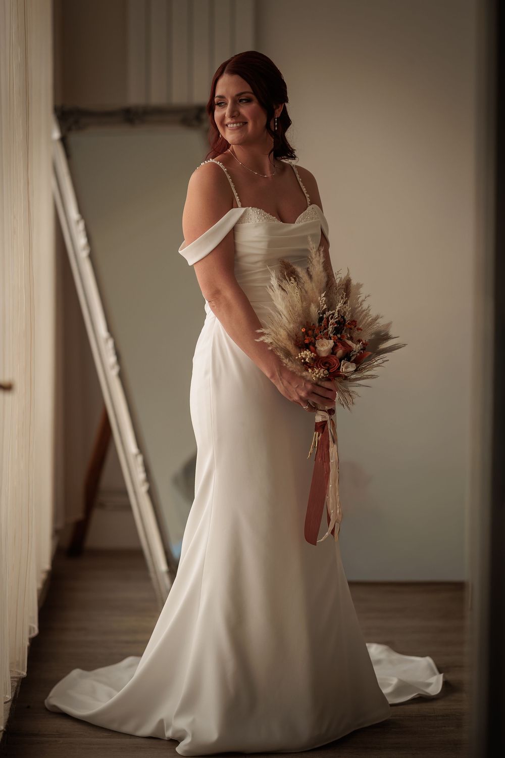 Elegant white wedding dress details shown in a series of intimate bridal portraits in soft lighting.